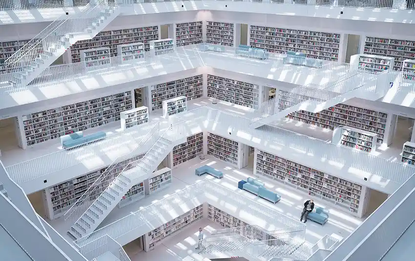 A shot looking down into a very white floored & wall multi-story library